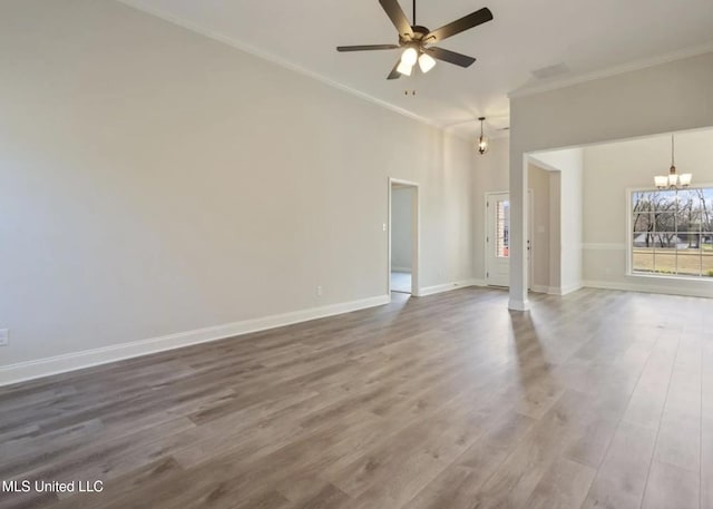 3752 Roland Dr, Southaven, MS 38672 - unfurnished living room featuring a chandelier, crown molding, healthy amount of natural light, ceiling fan, and wood finished floors