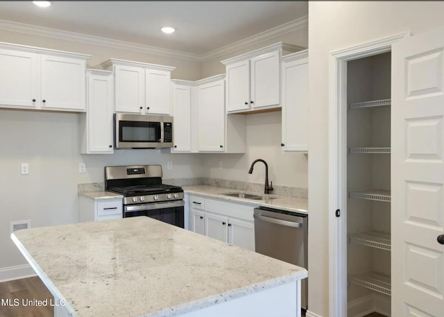 3752 Roland Dr, Southaven, MS 38672 - kitchen with appliances with stainless steel finishes, a sink, white cabinetry, ornamental molding, and recessed lighting