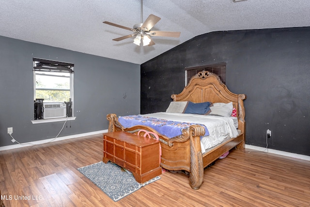 bedroom featuring lofted ceiling, ceiling fan, cooling unit, a textured ceiling, and wood-type flooring