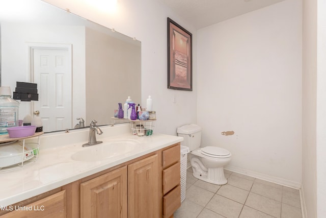 bathroom with tile patterned floors, baseboards, toilet, and vanity
