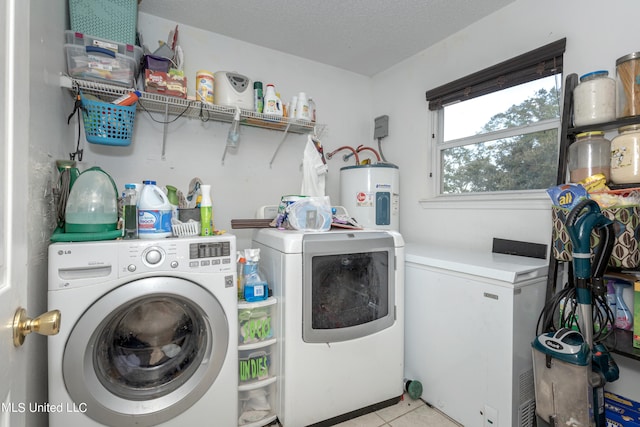 clothes washing area with light tile patterned floors, water heater, a textured ceiling, and separate washer and dryer