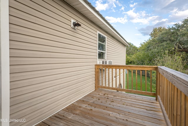 wooden terrace with a yard