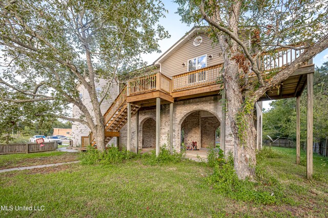 view of front of property featuring a deck and a front lawn