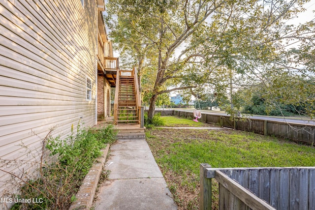 view of yard featuring stairs and a fenced backyard