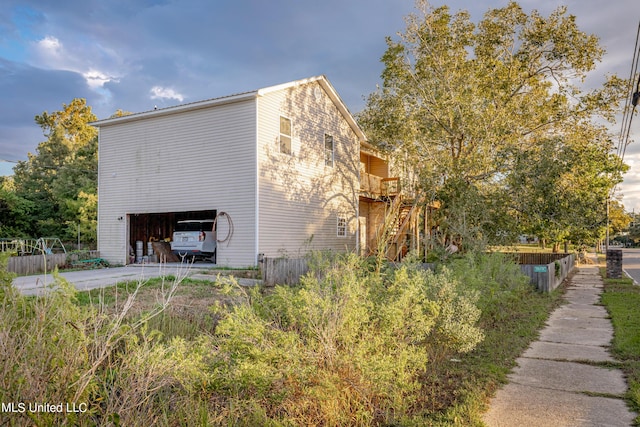 view of home's exterior featuring concrete driveway and a garage