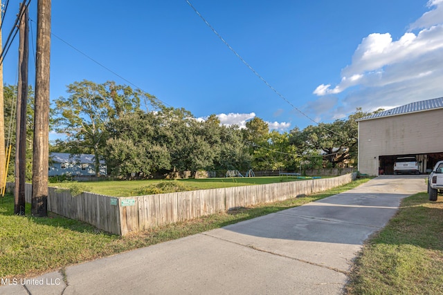 exterior space featuring driveway and fence