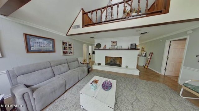 269 Weecama Dr, Ferriday, LA 71334 - living room featuring ornamental molding, a fireplace with raised hearth, a towering ceiling, and visible vents