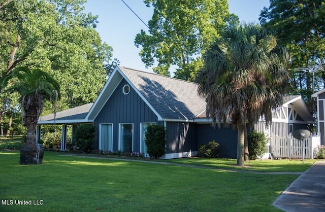 269 Weecama Dr, Ferriday, LA 71334 - view of front of house featuring board and batten siding, a shingled roof, and a front yard