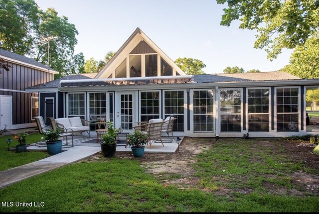 269 Weecama Dr, Ferriday, LA 71334 - rear view of house with a patio area, a sunroom, a yard, and roof with shingles