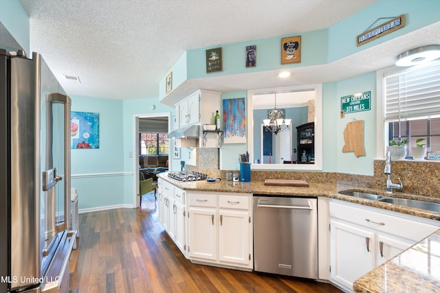 kitchen featuring white cabinetry, sink, stainless steel appliances, dark hardwood / wood-style floors, and a textured ceiling