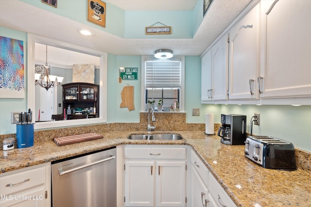 kitchen with white cabinetry, sink, stainless steel dishwasher, and a notable chandelier