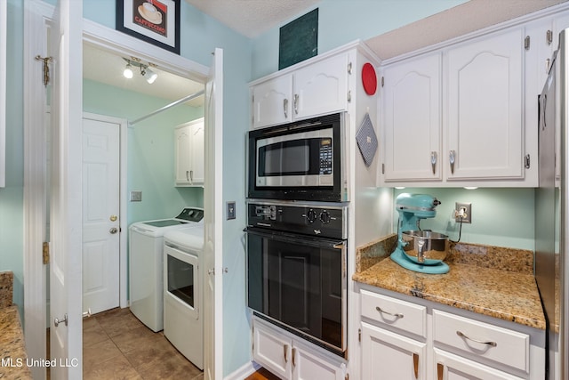 kitchen with light stone countertops, white cabinets, stainless steel appliances, and independent washer and dryer