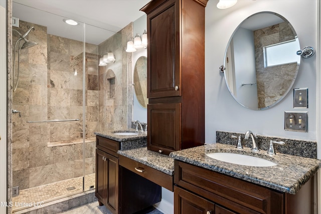 bathroom featuring vanity and a shower with door