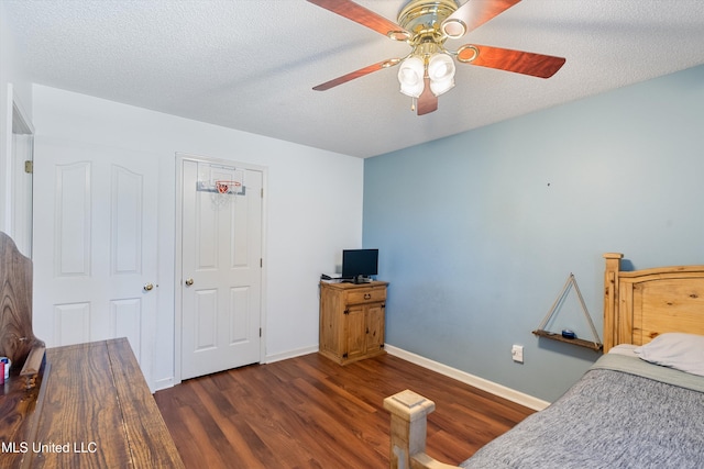 bedroom featuring a textured ceiling, ceiling fan, a closet, and dark hardwood / wood-style floors