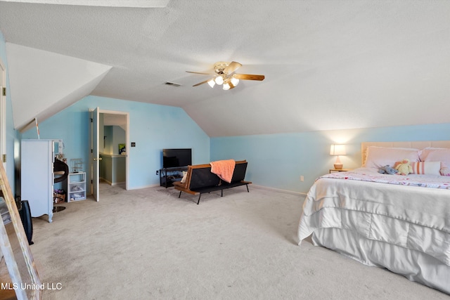 bedroom with carpet, a textured ceiling, ceiling fan, and lofted ceiling