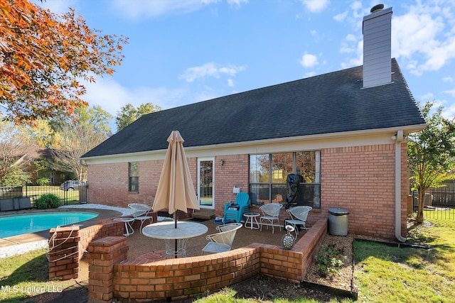 back of house featuring a fenced in pool and a patio area