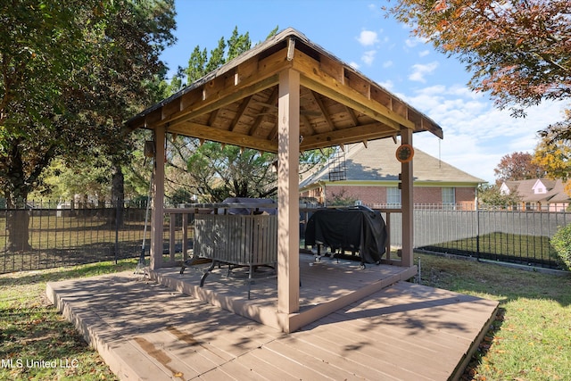 wooden deck with a gazebo and grilling area