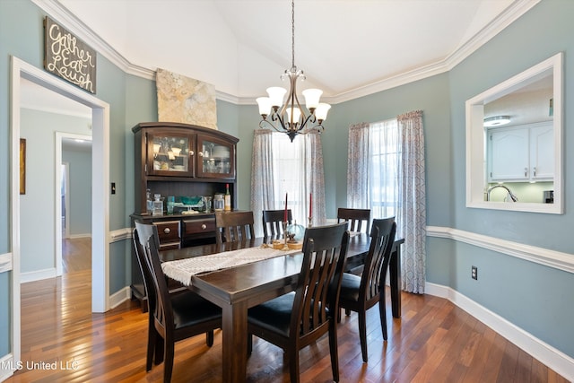 dining area with ornamental molding, dark wood-type flooring, and a chandelier