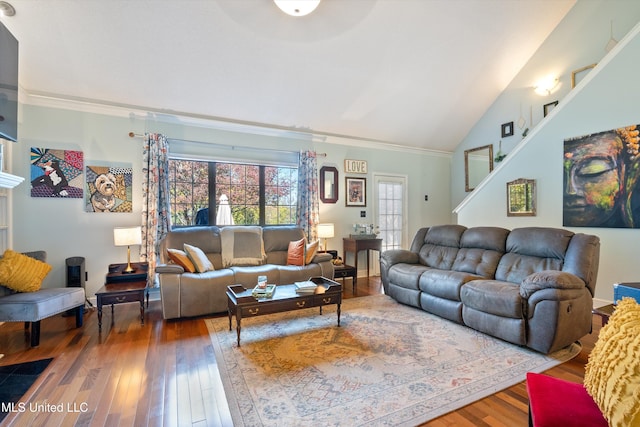 living room with wood-type flooring, vaulted ceiling, and ornamental molding