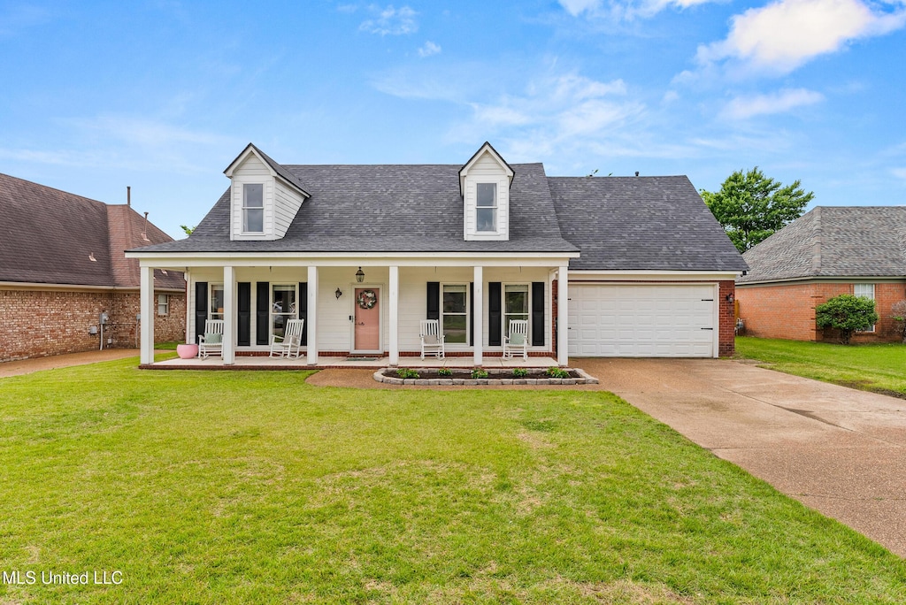 5643 Eagleston Dr, Olive Branch, MS 38654 - cape cod-style house with a porch, concrete driveway, an attached garage, and a front lawn