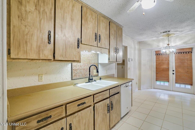 kitchen featuring hanging light fixtures, light tile patterned floors, dishwasher, a notable chandelier, and sink