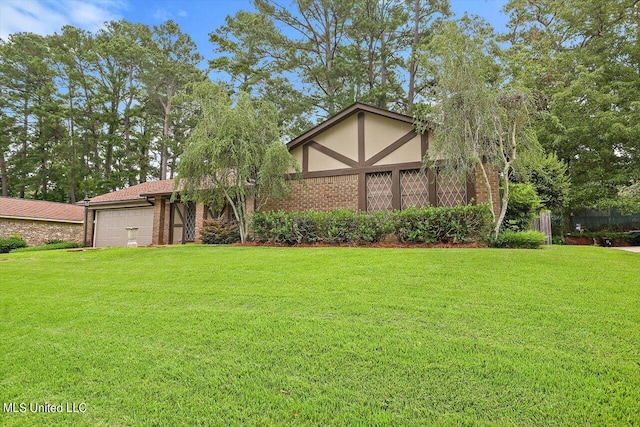 view of front of property featuring a garage and a front lawn