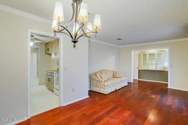 unfurnished room with hardwood / wood-style flooring, ornamental molding, a textured ceiling, and ceiling fan with notable chandelier