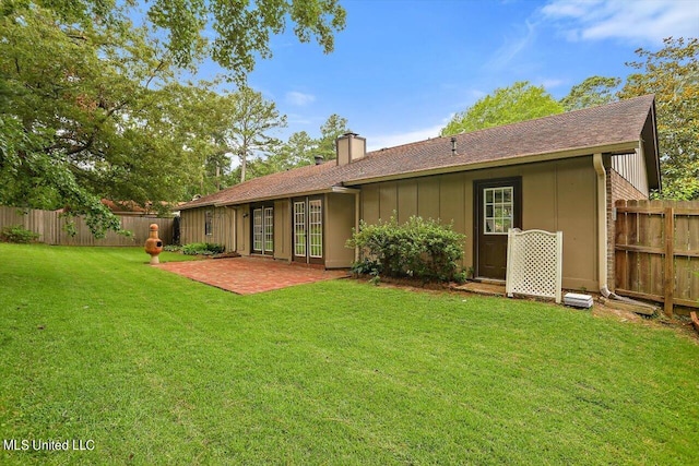 back of house featuring a yard and a patio