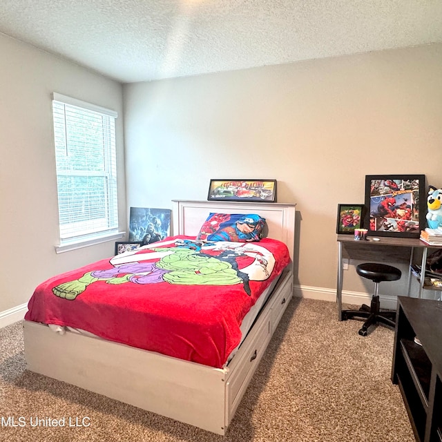 bedroom with a textured ceiling and light carpet