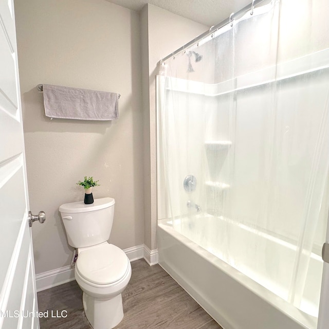 bathroom featuring toilet, shower / bath combo, and hardwood / wood-style flooring