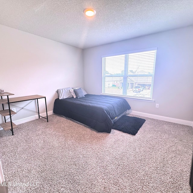 carpeted bedroom with a textured ceiling