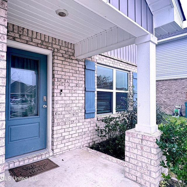 view of exterior entry featuring a porch