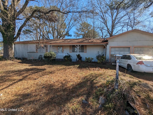 single story home featuring a garage and a porch