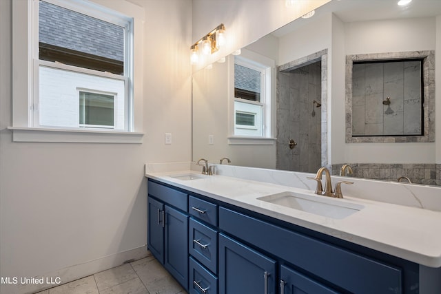 bathroom featuring vanity, tile patterned floors, and tiled shower