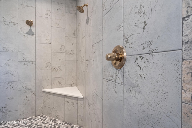 bathroom with a tile shower