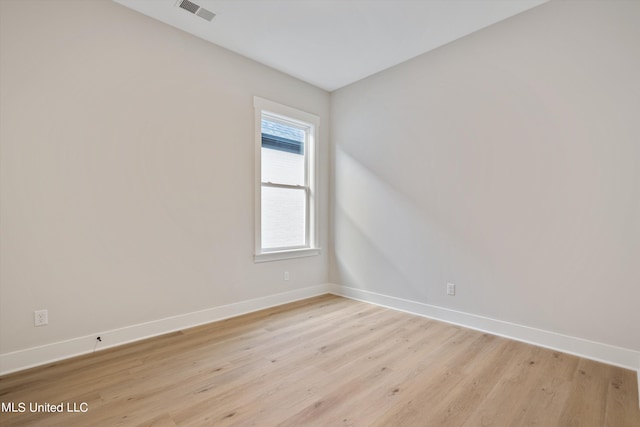 spare room featuring light hardwood / wood-style flooring