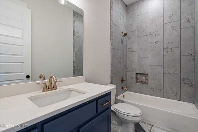 full bathroom with tiled shower / bath, vanity, and toilet