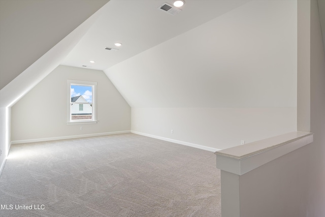 additional living space with carpet flooring and lofted ceiling