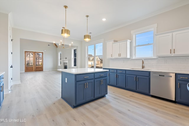 kitchen with white cabinets, stainless steel dishwasher, sink, and plenty of natural light