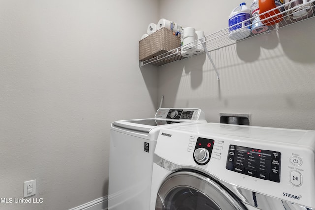 laundry area featuring separate washer and dryer and laundry area