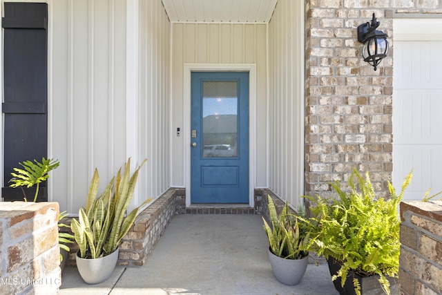 doorway to property featuring board and batten siding