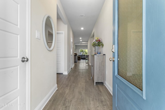 hall with recessed lighting, baseboards, visible vents, and wood finished floors