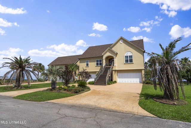 view of front facade with a garage and a front lawn