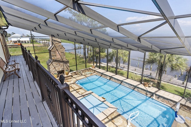 view of swimming pool featuring a yard, a patio area, and glass enclosure