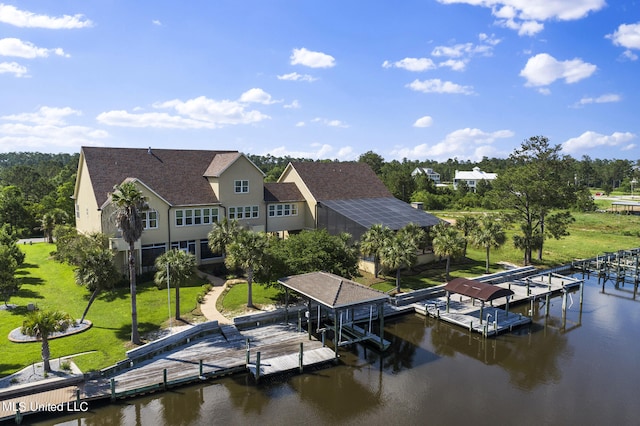 dock area with a water view and a yard