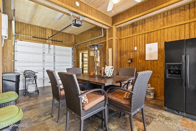 dining area featuring wood ceiling, wood walls, and beamed ceiling