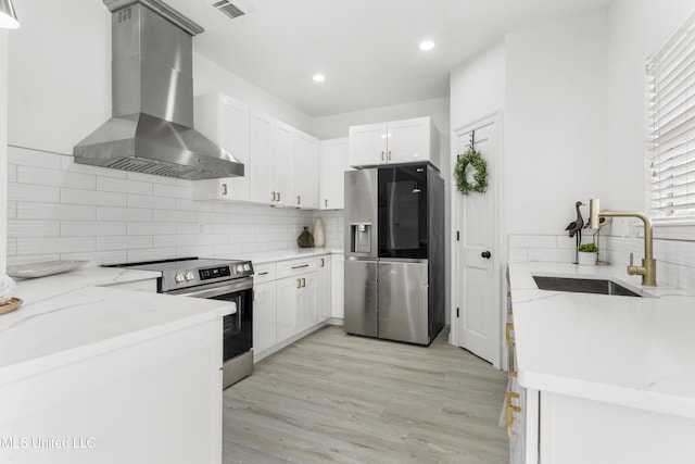 14789 Nassau Dr, Biloxi, MS 39532 - kitchen with appliances with stainless steel finishes, wall chimney exhaust hood, tasteful backsplash, light stone countertops, and recessed lighting