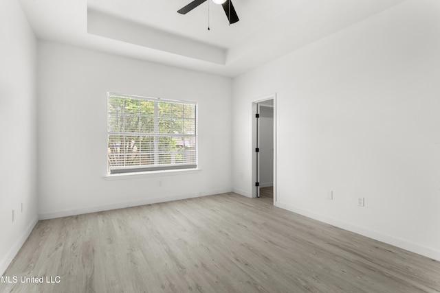 14789 Nassau Dr, Biloxi, MS 39532 - empty room with wood finished floors, a ceiling fan, and a raised ceiling