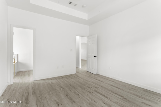 14789 Nassau Dr, Biloxi, MS 39532 - unfurnished bedroom with wood finished floors and a tray ceiling