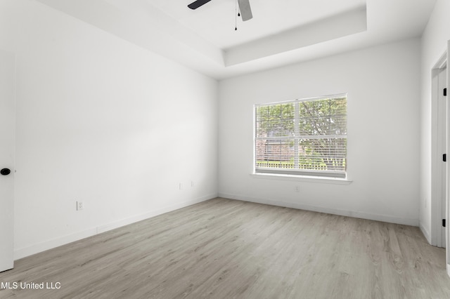 14789 Nassau Dr, Biloxi, MS 39532 - empty room with wood finished floors, a ceiling fan, and a tray ceiling